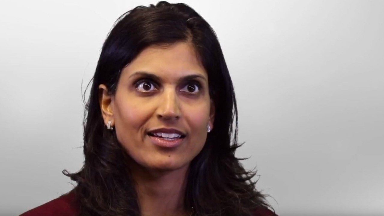 Dr. Anisha Patel seated in front of gray background