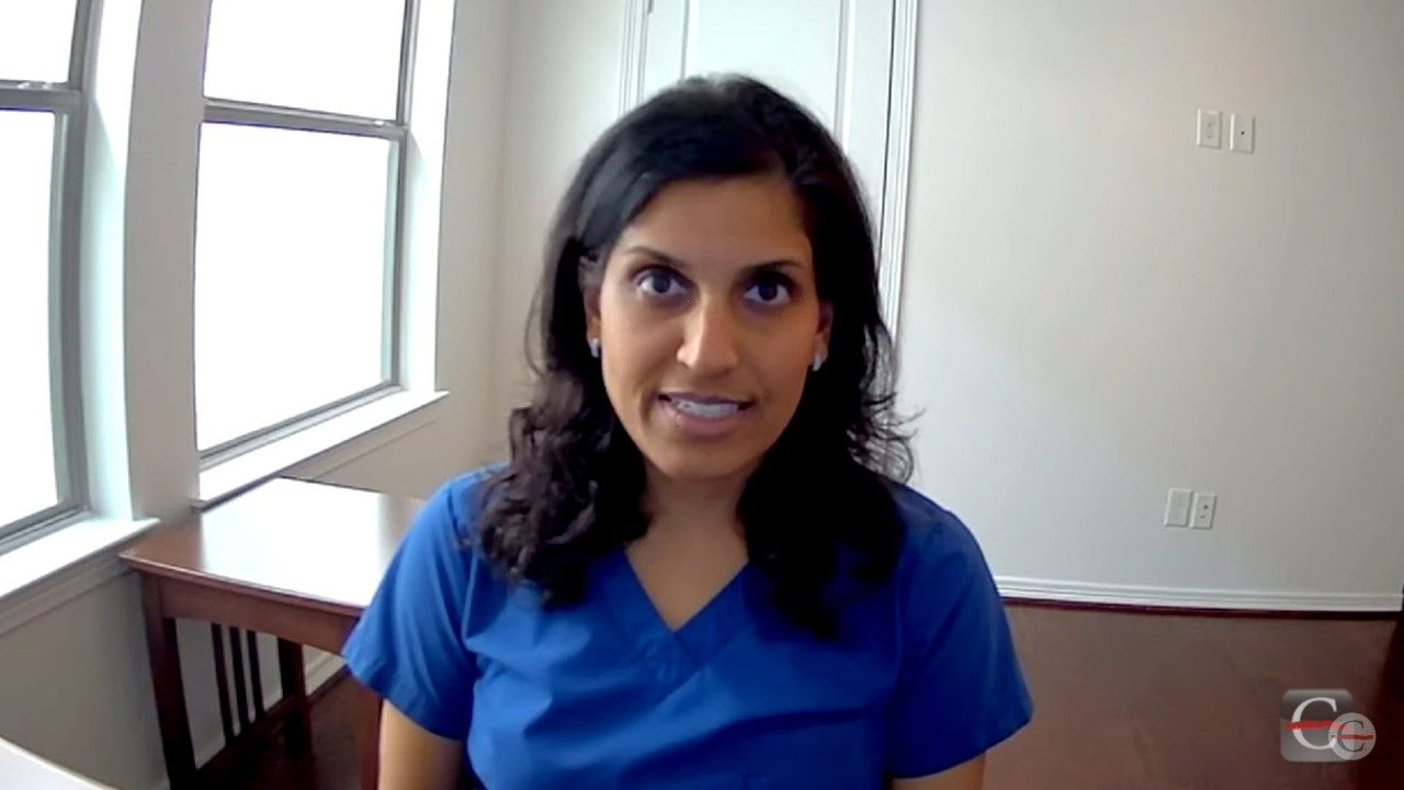 Dr. Anisha Patel sitting at desk