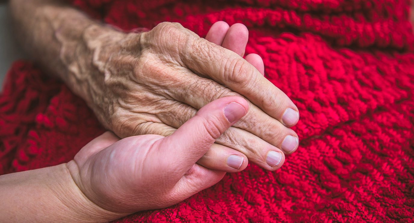 two hands holding each other in comfort