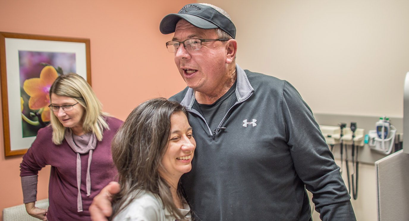 Max Nickless hugs Maria Cabanillas, M.D., after learning his thyroid cancer is shrinking.