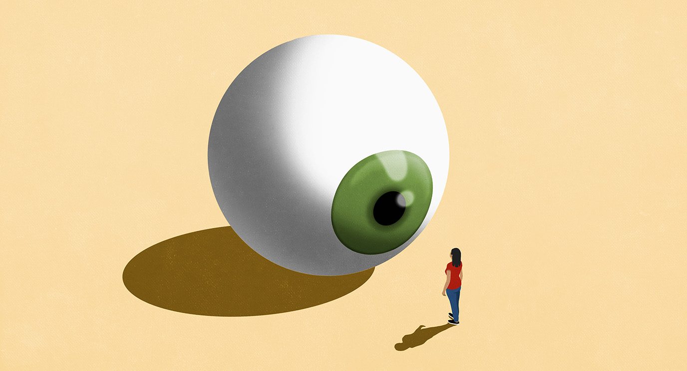 Woman staring at large green eyeball