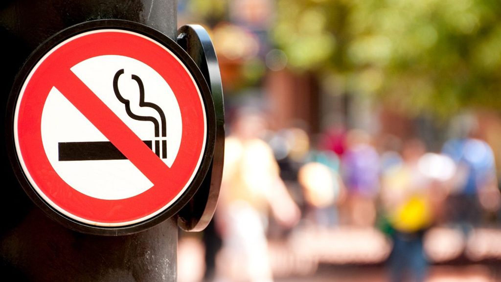 No smoking sign on a post in a public space