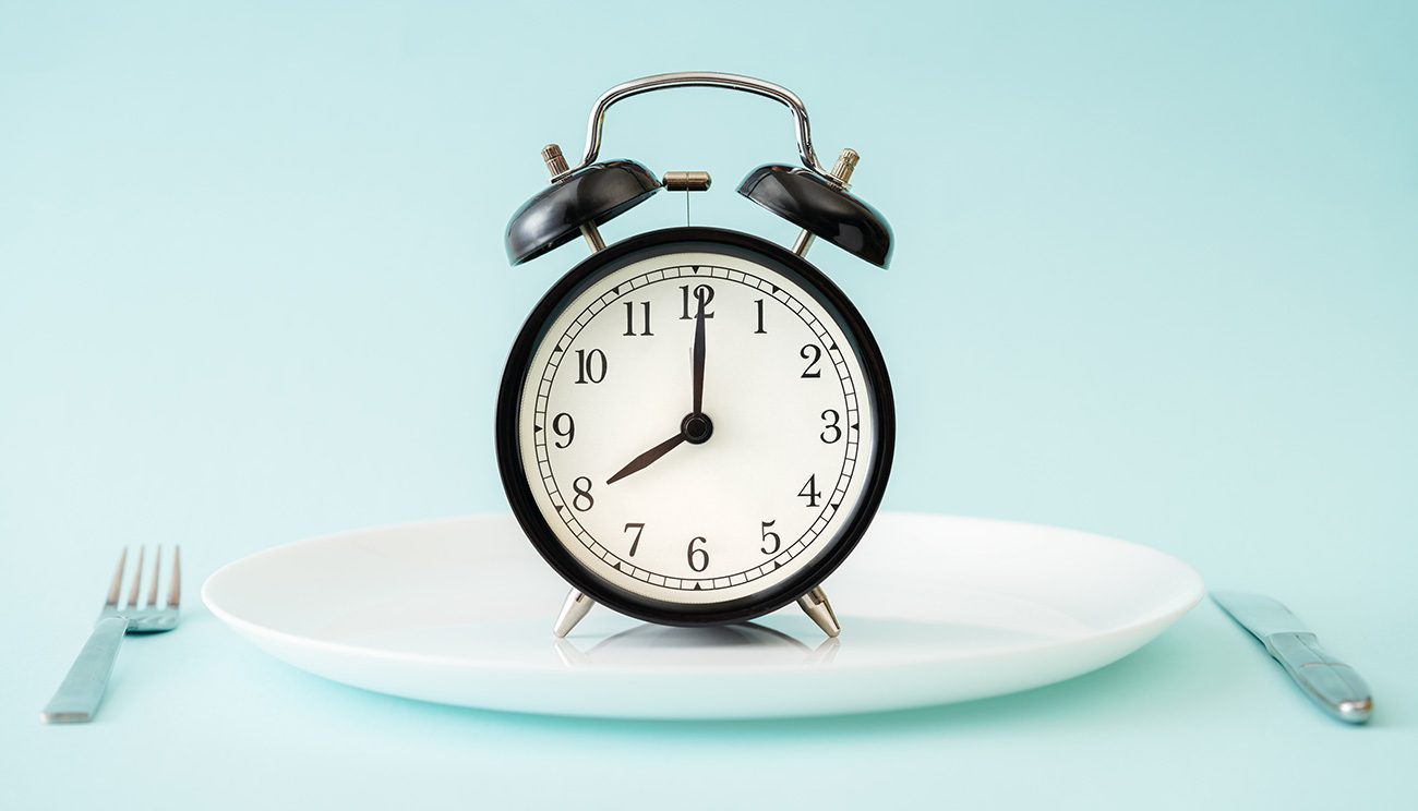 Clock on plate with silverware