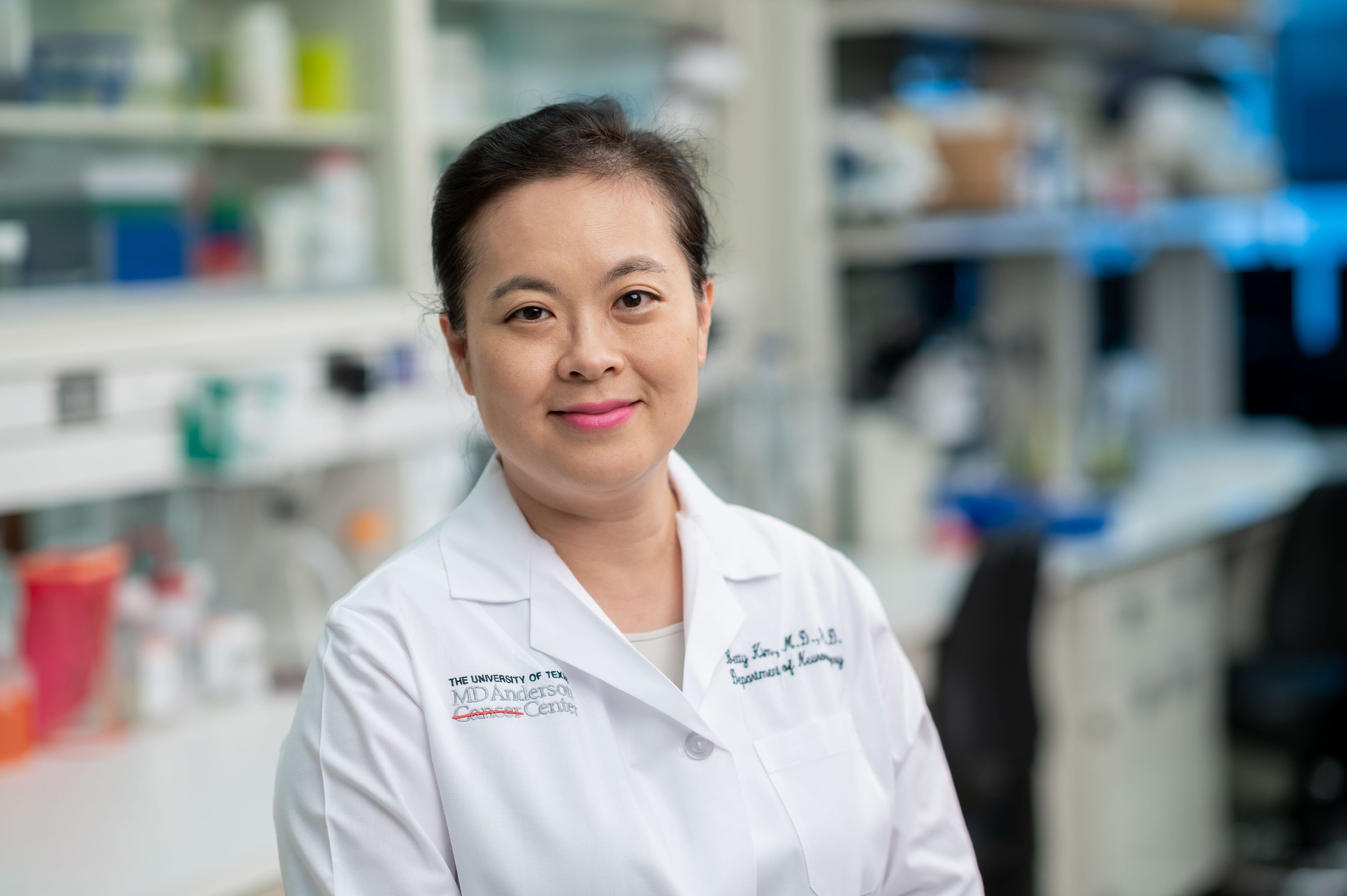 Dr. Betty Kim stands in her lab smiling