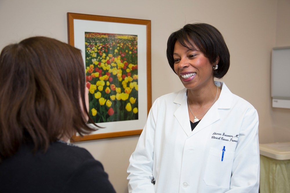 Abenaa Brewster, M.D., with a patient
