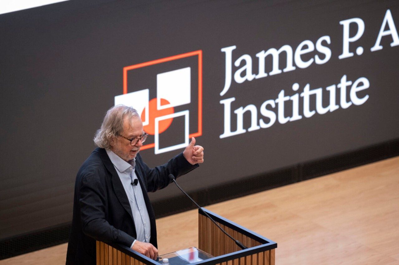 Dr. Jim Allison in a white lab coat