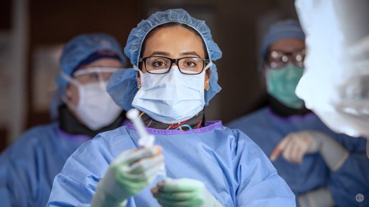 Dr. Saba Javed in scrubs and cap in operating room