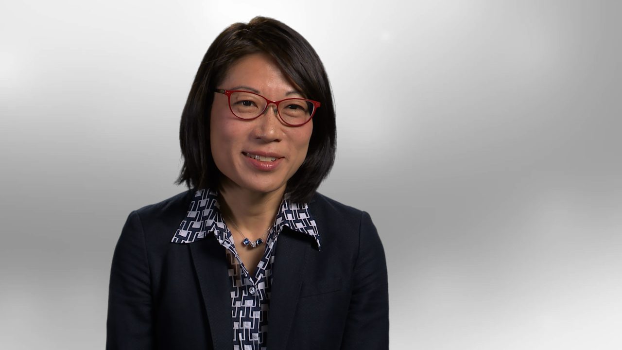 Dr. Nancy You sitting in front of gray background