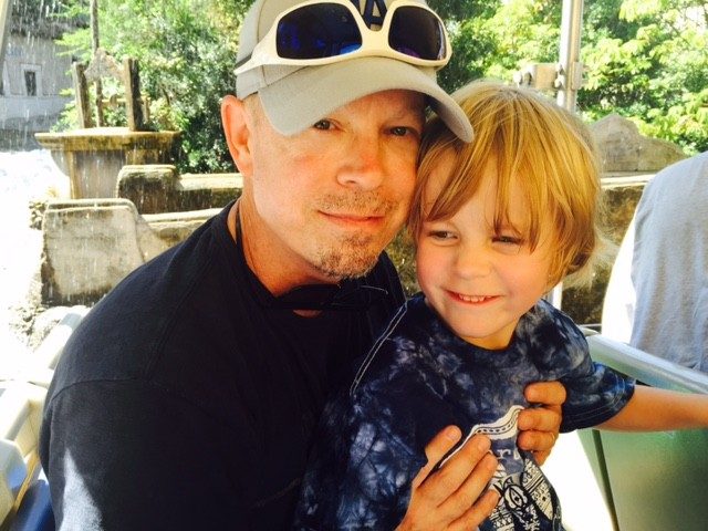 Throat cancer survivor and clinical trials participant Scot St. Martin with his youngest son, Sean
